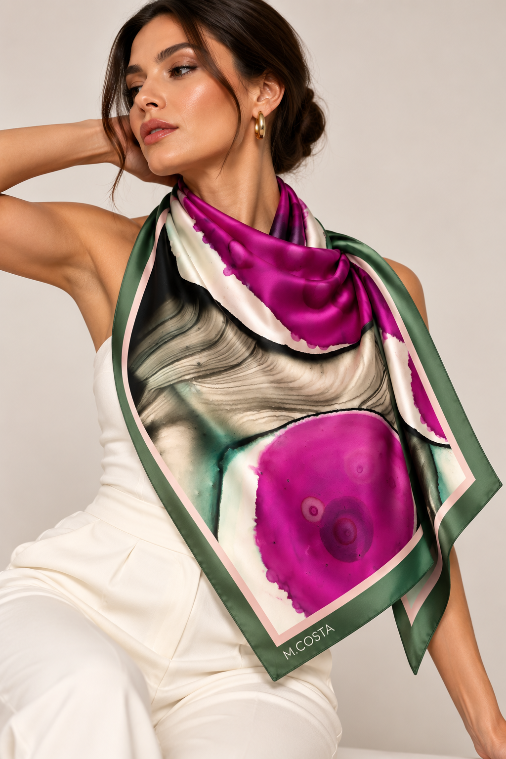 Model wearing M.COSTA Magdalena limited edition silk scarf in magenta, green, black and ivory