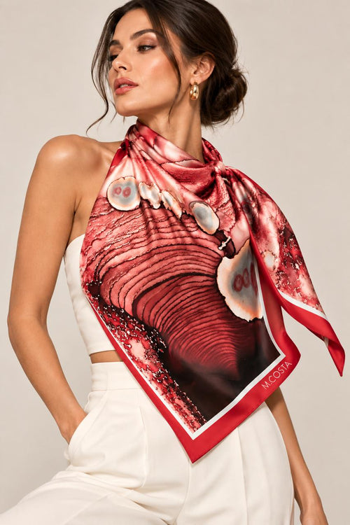 Model wearing M.COSTA Mariella limited edition silk scarf in red, coral, blush and burgundy