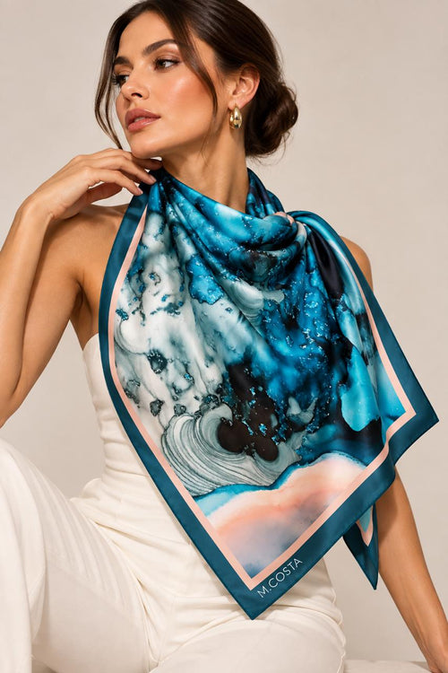 Model wearing M.COSTA Marina limited edition silk scarf in turquoise, teal, aqua and blush